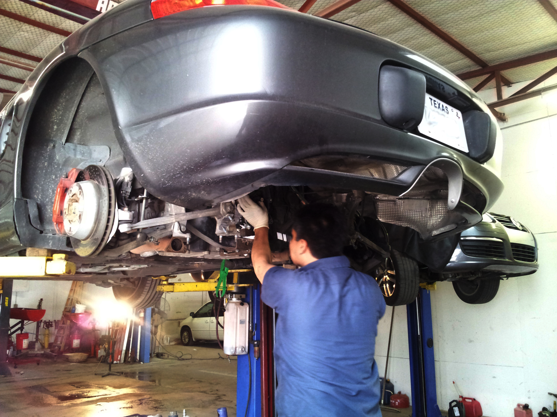 A mechanic repairing a Porsche transmission
